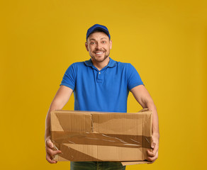 Courier with damaged cardboard box on yellow background. Poor quality delivery service