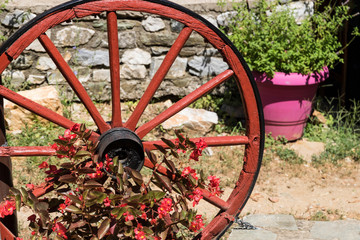 Landscape of Greece. View of Palaios Panteleimonas near Olimpic Mountain. Courtyard with wooden wheel.