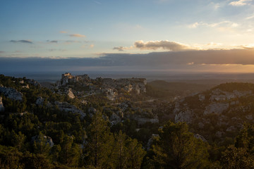View of the Baux de Provence at sunset from a vantage point in the Alpilles at sunset, south of France.
