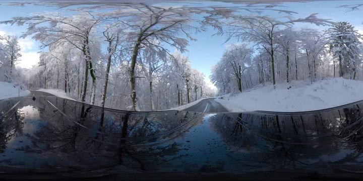 VR360 LD Car driving on a snowy road through forest in sunshine