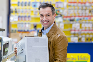 happy man just bought a printer at the hypermarket