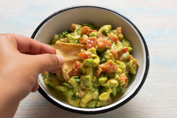 Mexican guacamole with tomato on white  background
