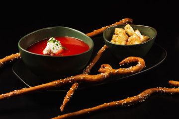 Gazpacho cold summer vegetarian tomato soup with creamy on a black background. Summer soup concept