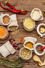 Zero waste food shopping concept. Cereals, pasta, legumes, dried mushrooms, spices. Sustainable lifestyle, old wooden boards background