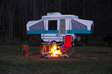 Pop Up Camper with camp fire in the woods,  Camping in the forest