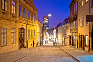 Fototapeta na wymiar Zagreb. Radiceva old cobbled street and Zagreb cityscape advent evening view