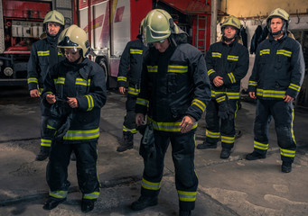 Group of firefighters standing confident with arms crossed. Firemen ready for emergency service.