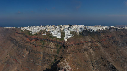 Aerial drone panoramic photo of beautiful and picturesque village of Imerovigli built up on a cliff at highest point overlooking the caldera, Santorini volcanic island, Cyclades, Greece
