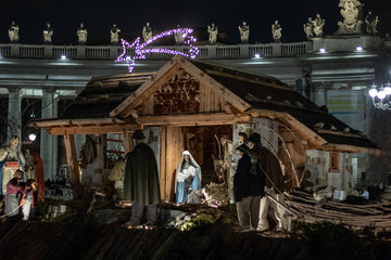 Rome Italy; 8 December 2019. In Piazza San Pietro the nativity scene reproduced with the wood of Trentino. With the Christmas tree in the background.