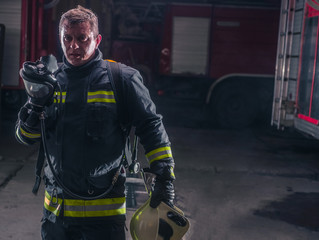 Firefighter with protective uniform wearing oxygen mask