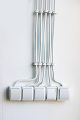 many light switches and cables on white background