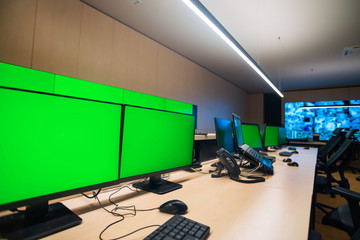 Empty office, desk, and chairs at a main CCTV security data center.