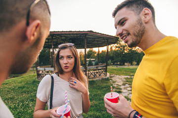 Friends having fun in city park at sunset