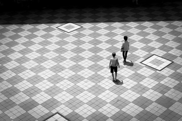 Filtered image aerial view two Asian ladies walking on patio tiles outdoor in Singapore