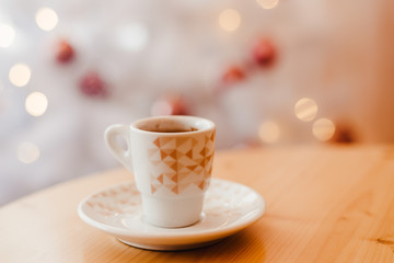 Cup of espresso or short coffee in white cup in cosy Christmas arrangement, festive decoration with...