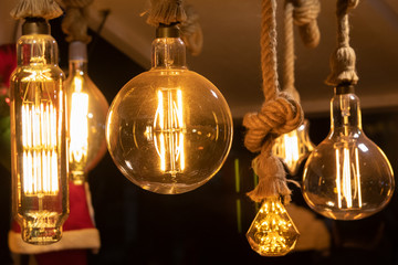 Fototapeta na wymiar Hanging light bulbs fastened with ropes