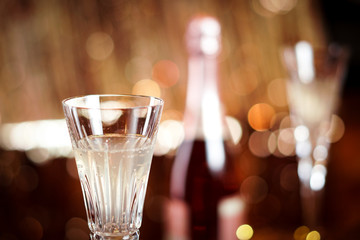 Champagne flute glasses celebration scene with lights and bokeh balls