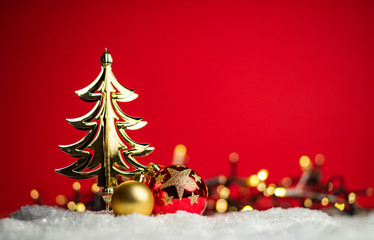 Fototapeta na wymiar shiny golden Christmas tree on red background