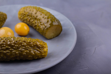 Three pickles on a plate