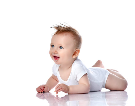 Infant child baby boy kid with blue eyes lying happy smiling screaming isolated on a white 