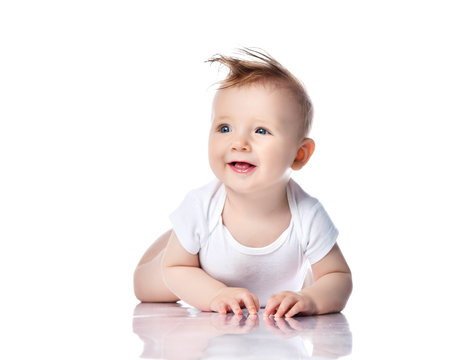 Infant child baby boy kid with blue eyes lying happy smiling screaming isolated on a white 