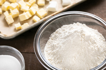 Baking flour and ingredients beside a sheet pan with butter