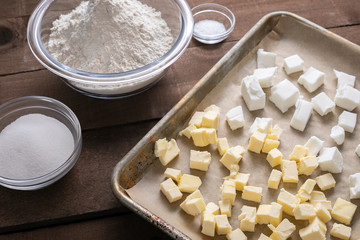 Baking sheet of butter and shortening, beside bowls of ingredients