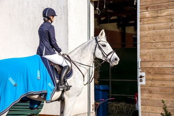 Horse riding . Young girl riding a horse . Equestrian sport in details.