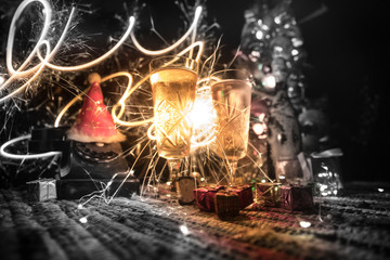 Traditional winter holiday alcohol drink in snow with creative New Year artwork. Copy space. Selective focus