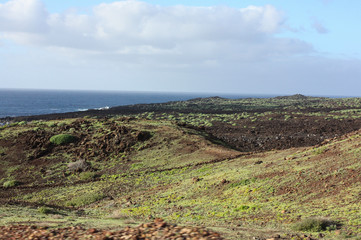 Green lake with volcanic black sand