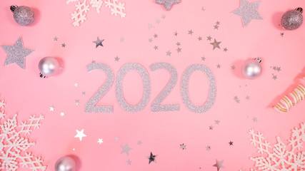 2020 Christmas and new year background banner with the beautiful decor gift for holiday in winter. On bright pink, golden and silver color theme with snow flake. top view with copy space.