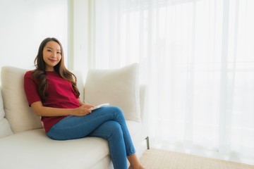 Fototapeta premium Portrait beautiful young asian women happy smile sit on sofa