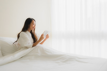 Portrait beautiful young asian women read book on bed
