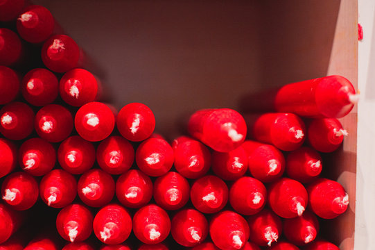 red Christmas candles. Close up picture of  red candles for christmas or valentines day. Neatly organised in a stack.