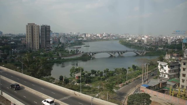 Dhaka city beautiful top view, over bridge with lake, buildings and cars transportation.