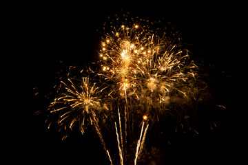 Gold fireworks on black background for winter and new year festivals.