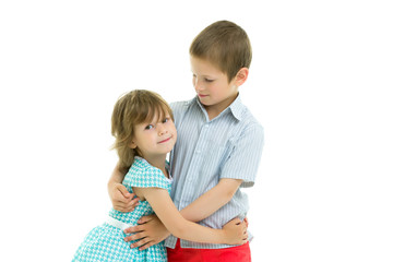 Boy and girl brother and sister gently hug