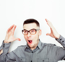 young handsome teenage hipster guy posing emotional wearing glasses, happy smiling lifestyle people concept