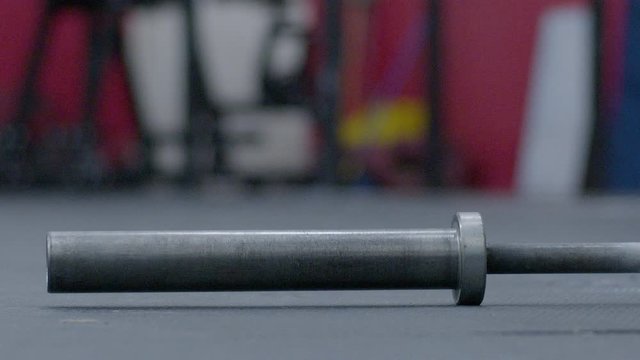 Gym barbell falling to the ground