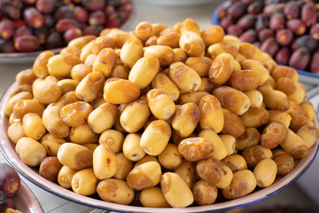 A pile of fresh organic dates freshly picked and ready to eat. Al Ain, Abu Dhabi, United Arab Emirates.