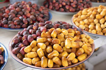 A pile of fresh organic dates freshly picked and ready to eat. Al Ain, Abu Dhabi, United Arab Emirates.