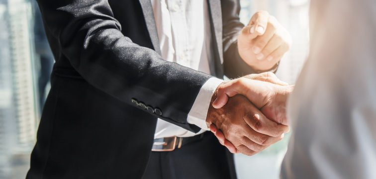 businessman handshake for teamwork of business merger and acquisition	