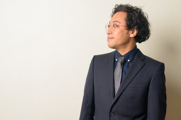 Profile view of Japanese businessman in suit thinking