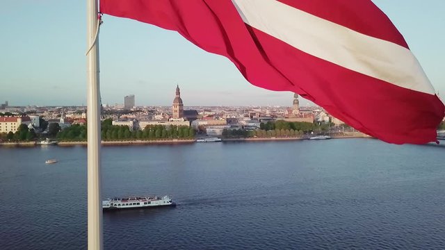 Latvia flag Riga city drone flight Daugava river bottom to top