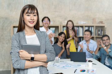 Leadership asian creative woman or head staff employee feeling happy and smiling is standing out of...
