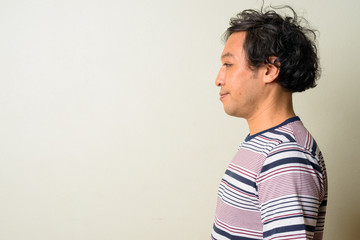 Profile view of Japanese man with curly hair