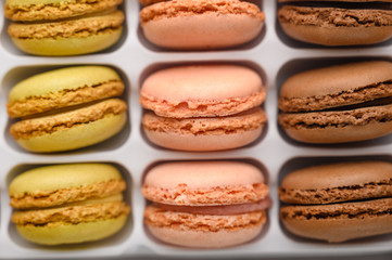 background with an assortment of colored french sweets macaroon, selling a shop or cafeteria, restaurant. Tastes and sweets