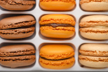 background with an assortment of colored french sweets macaroon, selling a shop or cafeteria, restaurant. Tastes and sweets