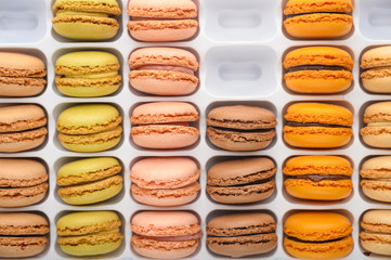 assortment of multi-colored french macaroons, delicious sweets. Background, top view