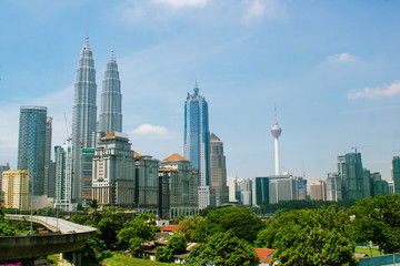 Fototapeta premium Kuala Lumpur, Malaysia - April 12, 2013. View from the bus window to the city center of Kuala Lumpur, view of the Petronas Towers and the Menard Tower.